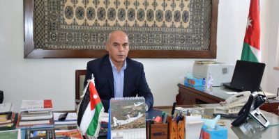 Ambassador of Jordan posing for a picture in his office